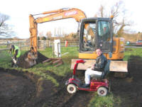 Bandstand Project: Trustee Colin supervises the work